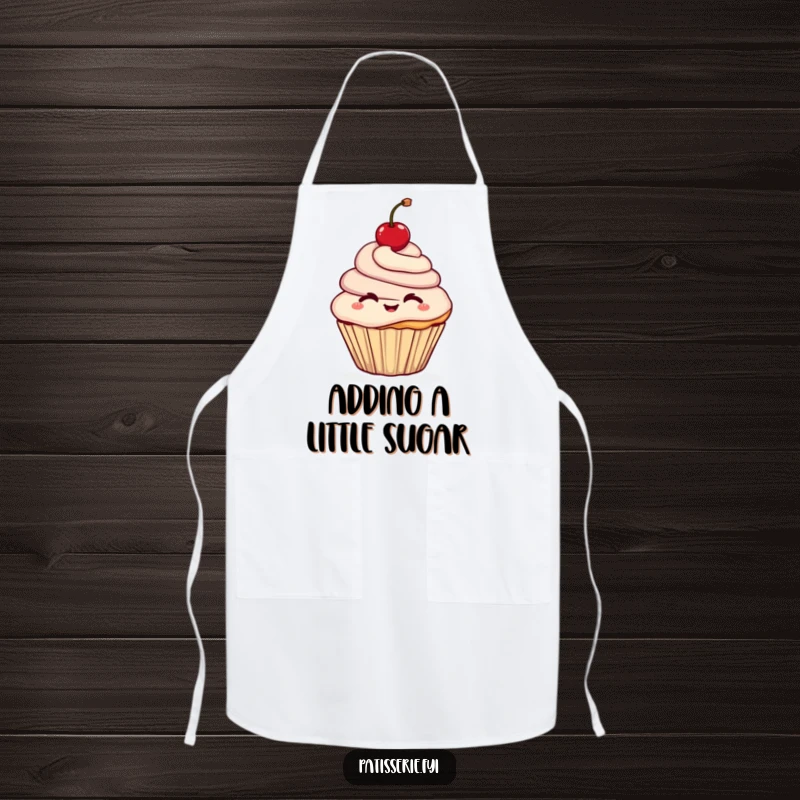 Funny apron showcasing a cheerful cupcake character winking while holding a cherry aloft, perfect for sweet baking sessions.