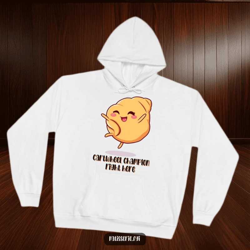 Funny croissant hoodie showcasing a winking pastry performing an impressive cartwheel, ideal for comfortable and humorous lounging.